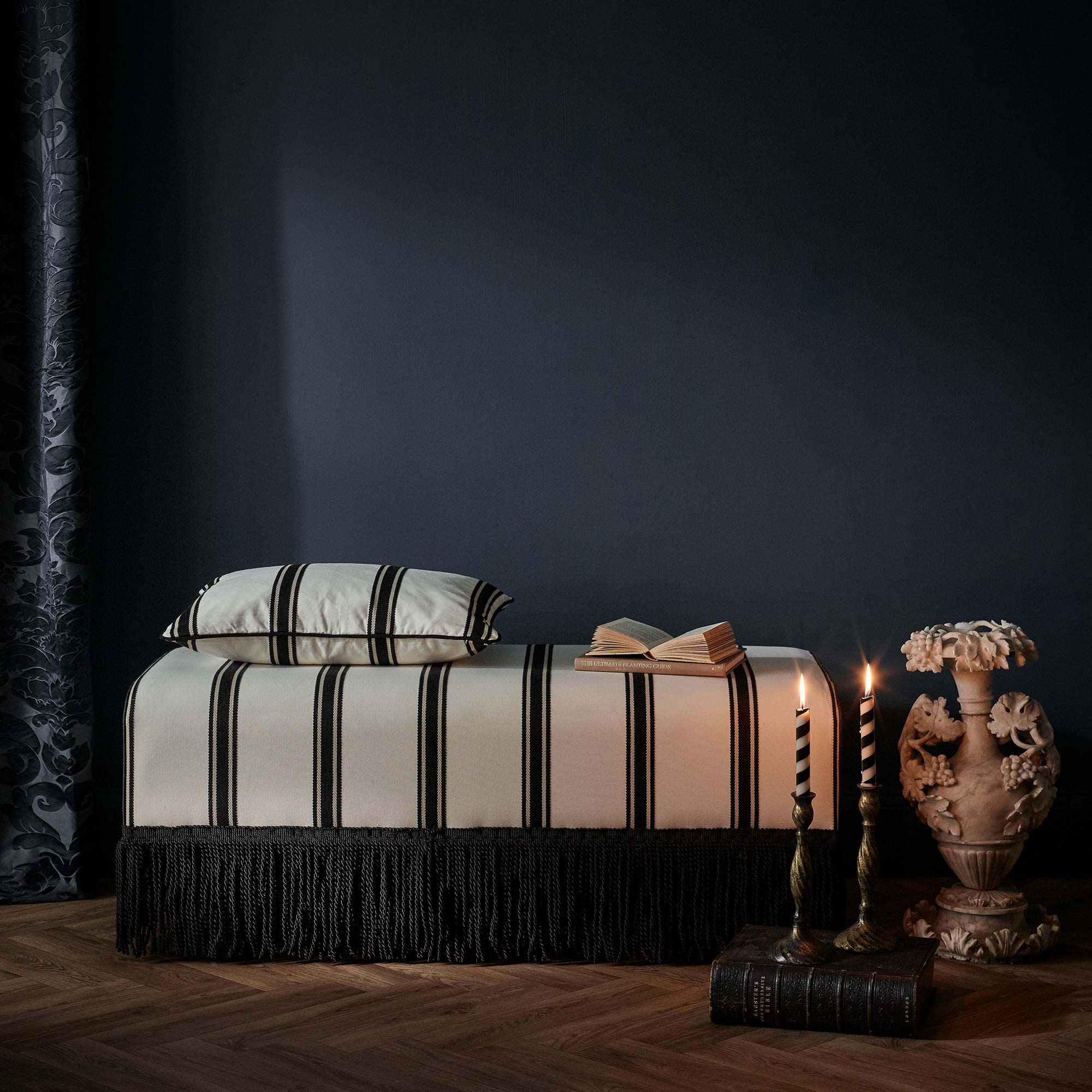black and white stripped bench with black tassel details 