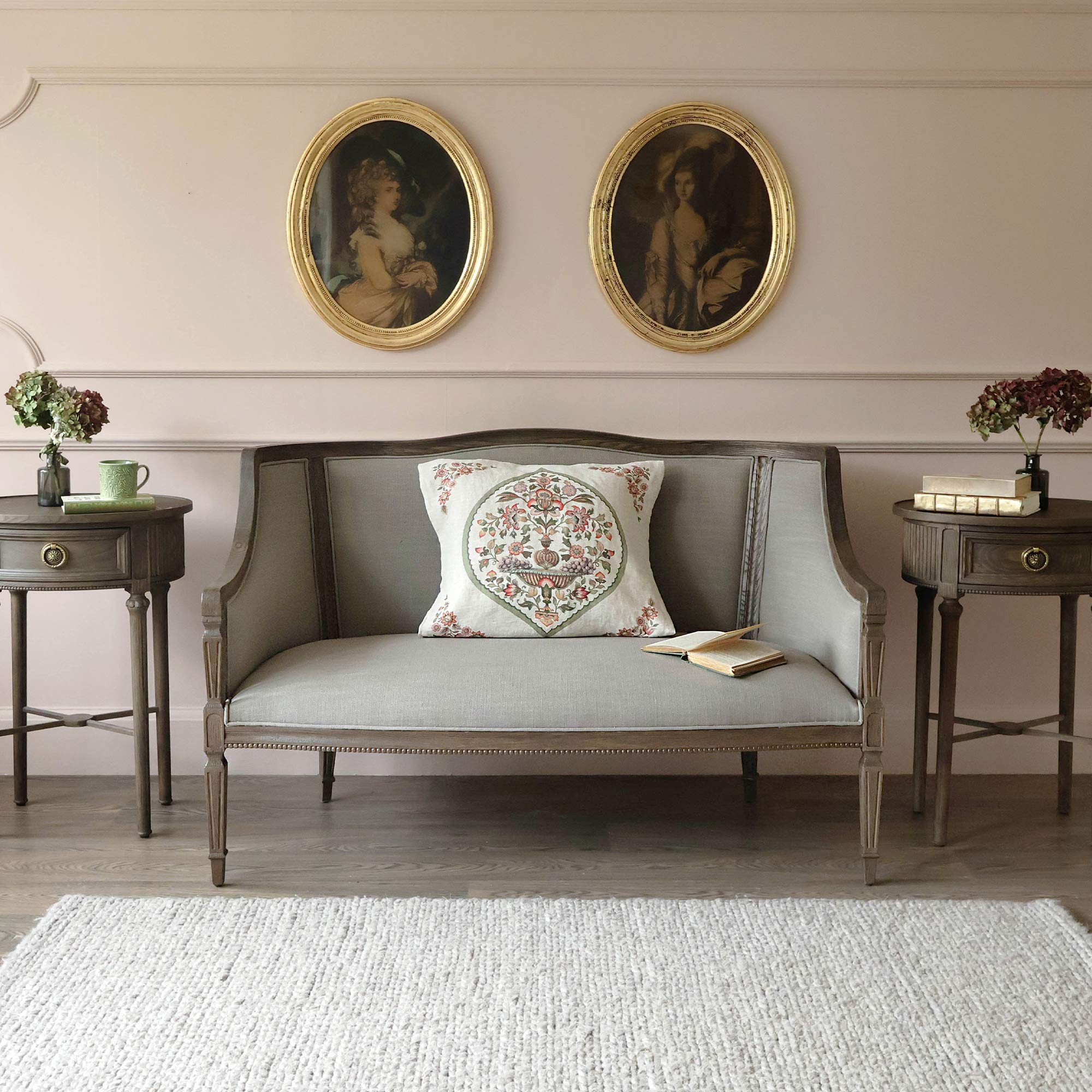 Gustavian Dark Sofa in ash wood with natural linen upholstery, styled with embroidered mulberry cushions and matching Gustavian Dark Oval Nightstands.